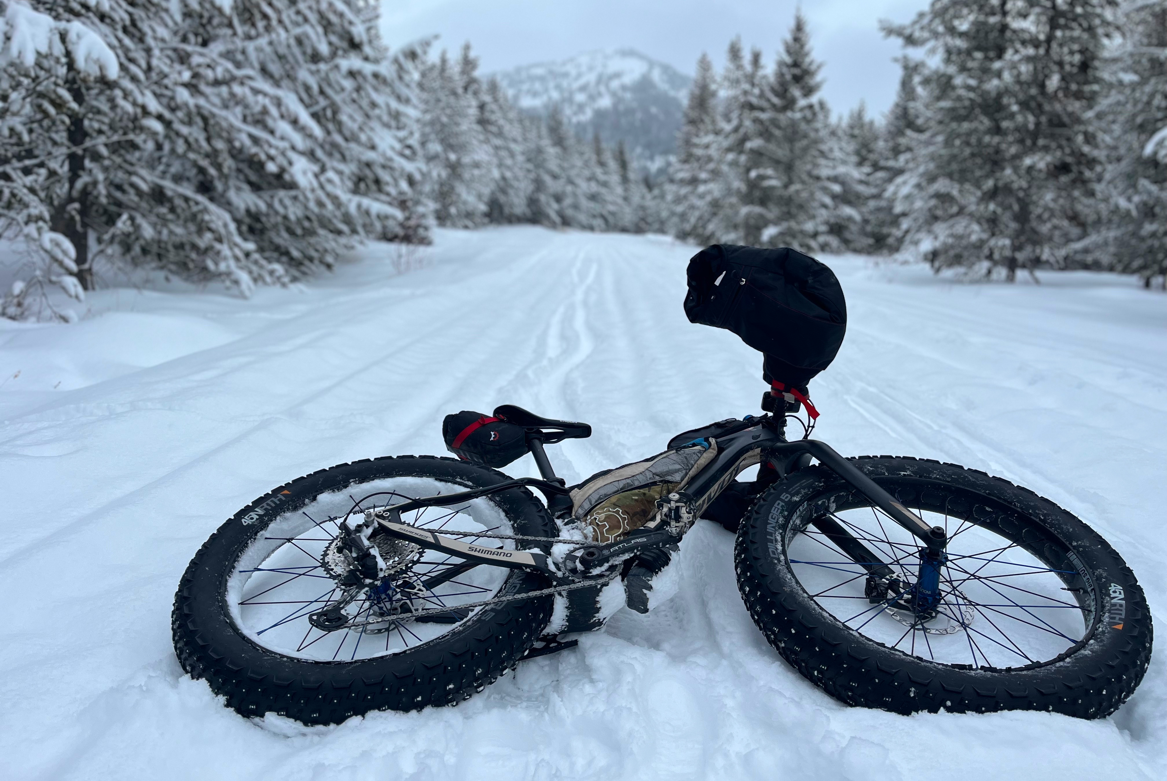 A bicycle resting on a snow-covered road