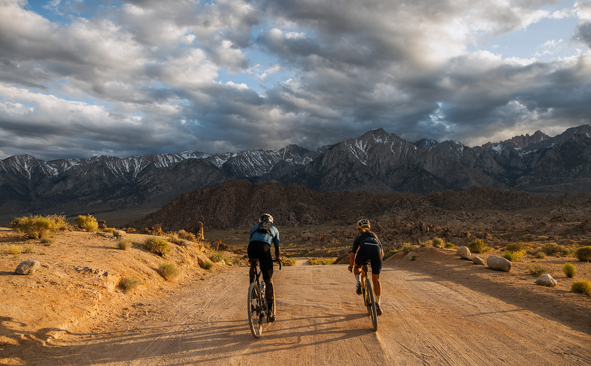 two cyclists on a dirt road