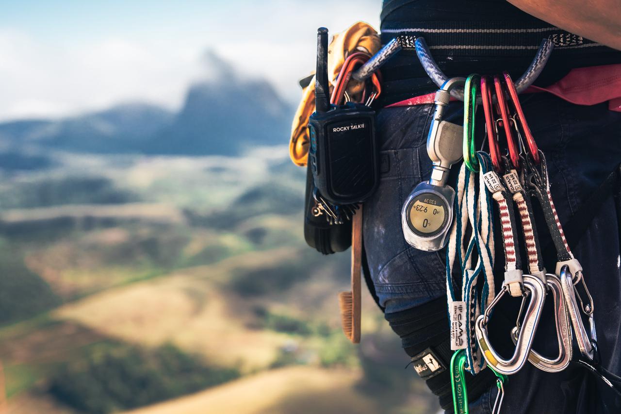 Sunrise or sunset from the portaledge, with a team member visible looking out. Candidate for the piece's largest image.